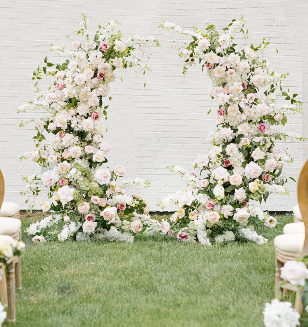 Wedding Pillars with beautiful soft blush garden roses, ballet pink dahlias, soft blush peonies, white garden roses, white playa blanca roses, blush ranunculus, mauve roses, ivory hydrangeas, blush sweet pea's, white ranunculus, and white delphinium, with touches of eucalyptus, peach juliet garden roses, and clematis. 