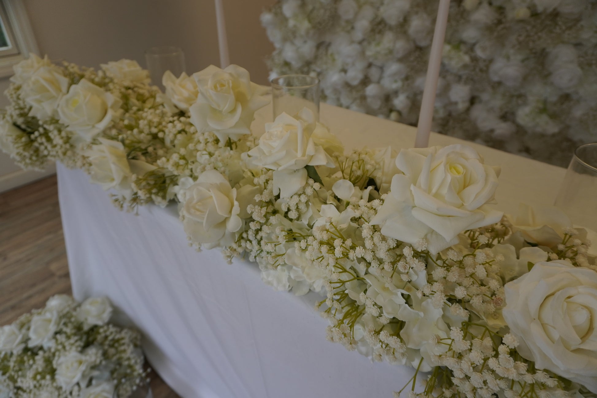 Up close of these babys breath and white roses wedding decor flower pieces.