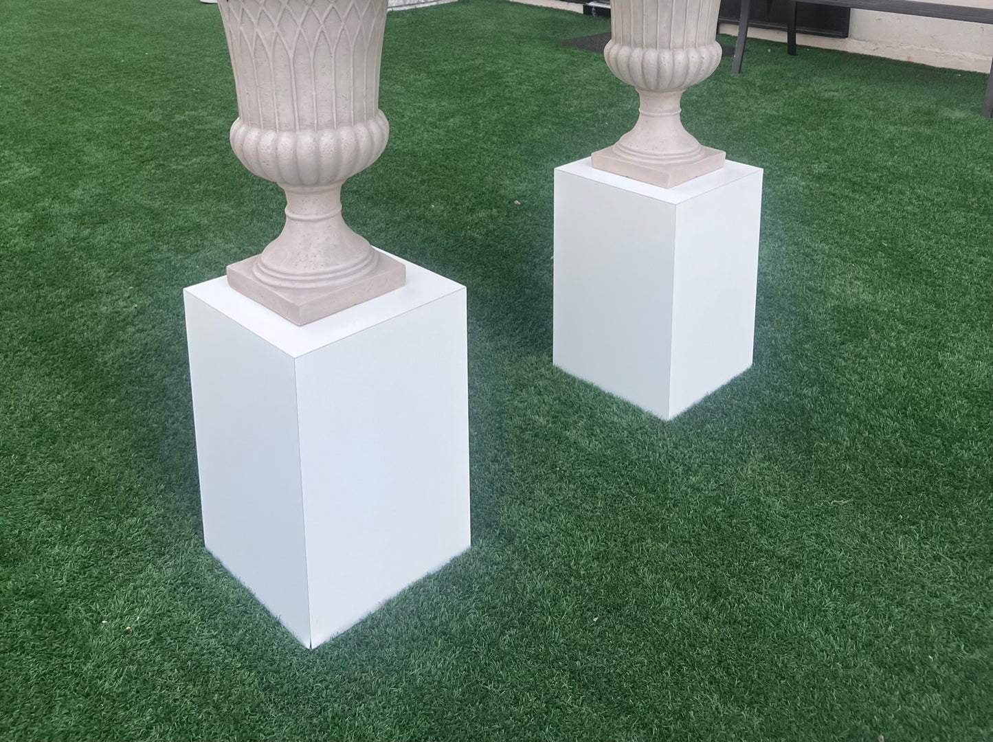 Modern white urn pedestals for wedding rentals to set Urns or flower arrangements on. 